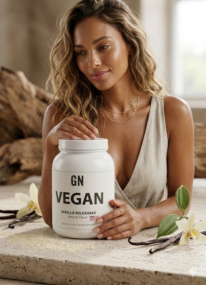 Woman holding a GN Vegan protein powder container with vanilla flowers and vanilla beans on a wooden surface.