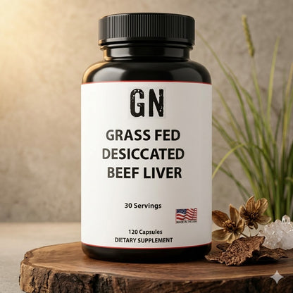 Supplement bottle labeled 'GN Grass Fed Desiccated Beef Liver' on a wooden surface with a plant in the background.